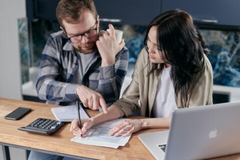 Man and woman reviewing cooling bills