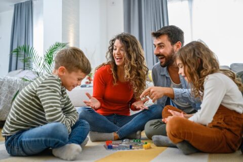 Parents playing board games with kids at Utah County