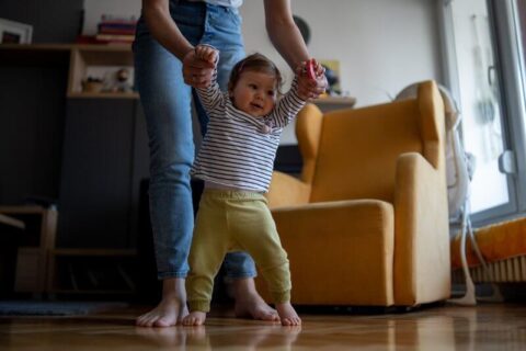 Baby walking barefoot on heated floor