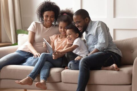 Parents reading with children on tablet
