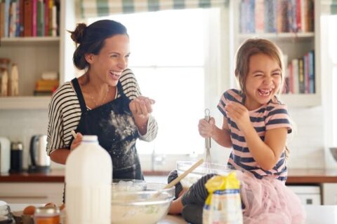 Mother and Daughter having fun baking in kitchen