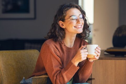 Woman drinking hot tea in home